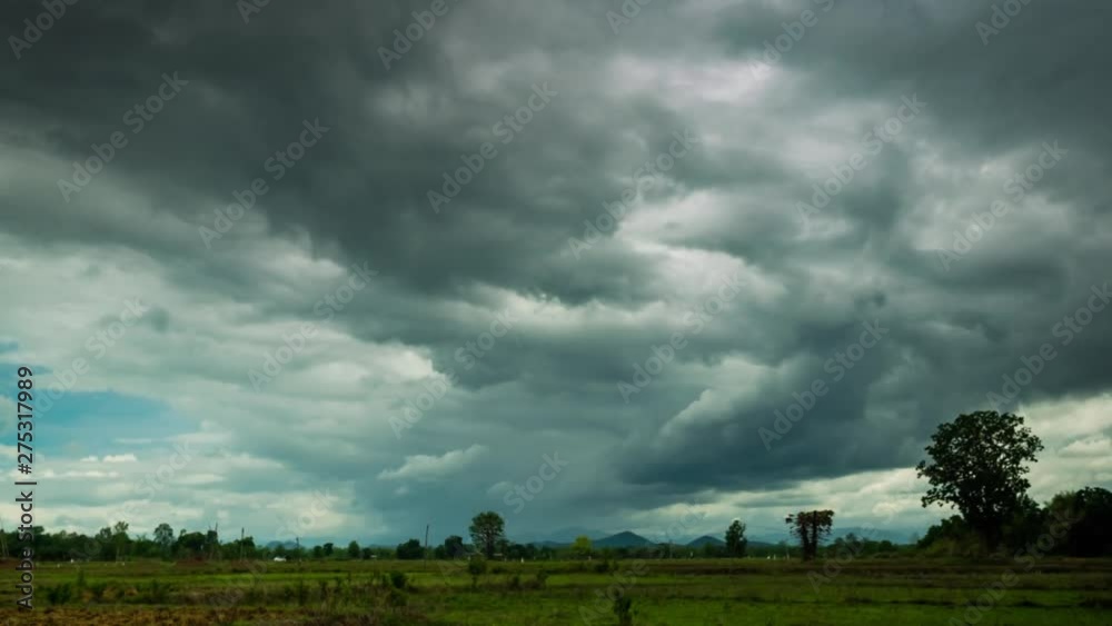 Rain clouds moving in the sky over the paddy field in rural of Thailand Rain clouds moving in the sky over the paddy field in rural of Thailand