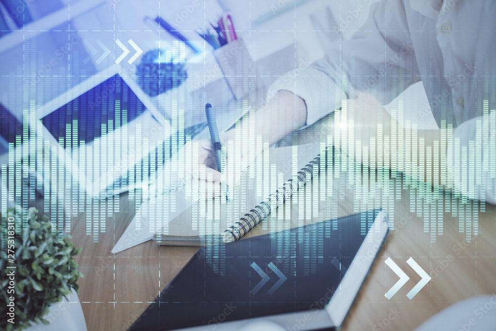 Financial graph displayed on woman's hand taking notes background. Concept of research. Double exposure Financial graph displayed on woman's hand taking notes background. Concept of research. Double exposure