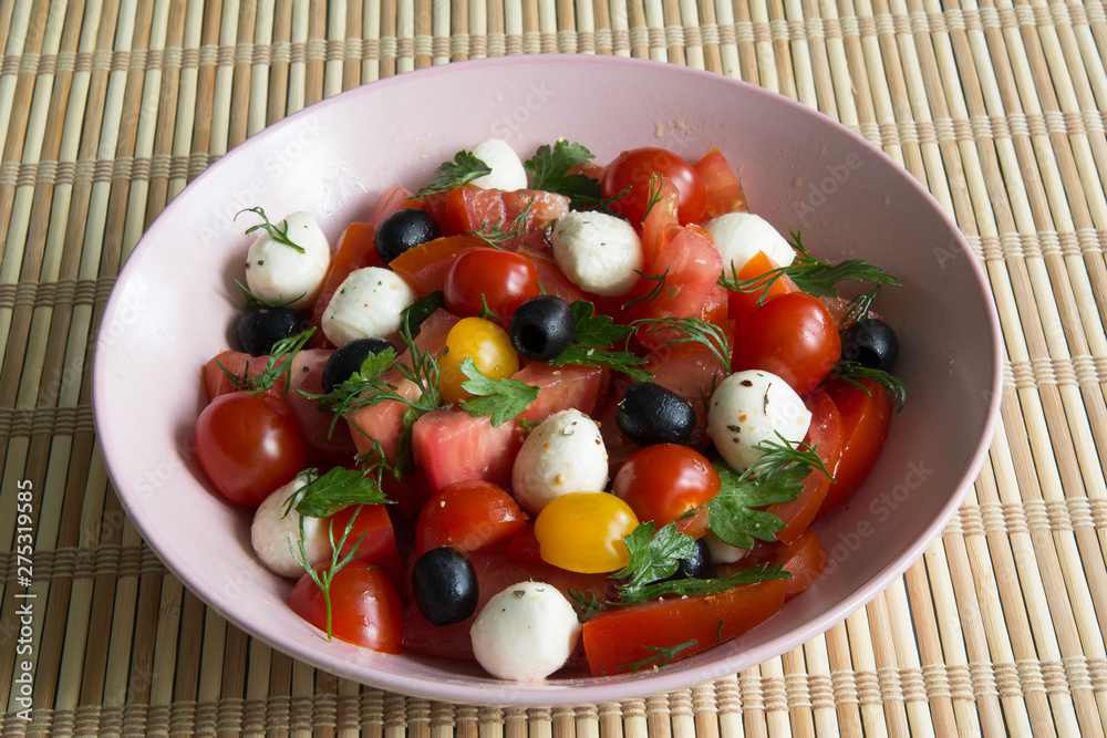 Salad with tomatoes, olives and mozzarella cheese Salad with tomatoes, olives and mozzarella cheese