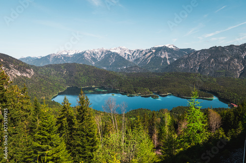 View onto crystal clear blue Eibsee as seen from track of Bavarian Zugspitz Railway on its ascent to Zugspitze during clear summer day (Grainau, Germany, Europe)