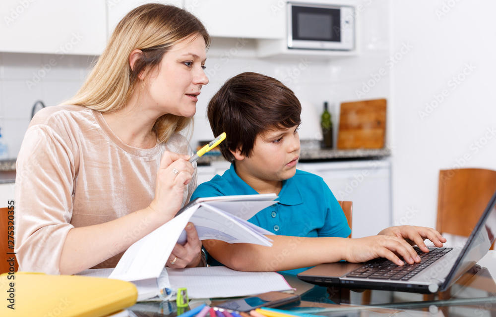 Fototapeta premium Family doing homework at kitchen