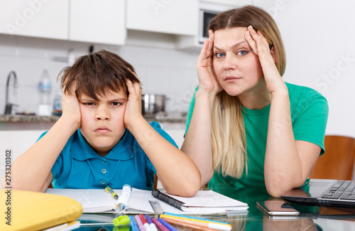 Displeased family doing homework photo