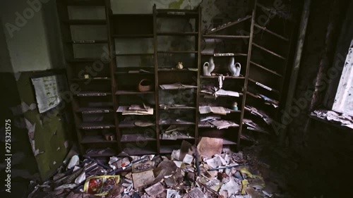 View inside mysterious dangerous old apartment building in Prypiat city. Capboard with left books and goods from inhabitants. Chernobyl, north of Ukraine. photo