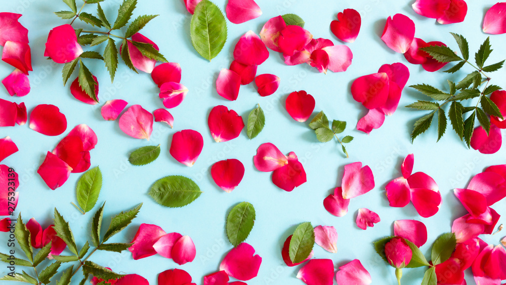 Creative arrangement of red flowers and leaves on pastel blue background wiyh paper card note. Blooming rose concept. Flat lay. Minimal nature. Creative arrangement of red flowers and leaves on pastel blue background wiyh paper card note. Blooming rose concept. Flat lay. Minimal nature.
