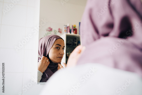 Photography Close-up of mature woman wearing hijab while looking at mirror