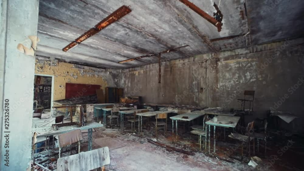 Impressive view inside dirty old classroom destroyed with time inside abandoned school in Prypiat city. Tour to dangerous ghost town in Chernobyl Zone, Ukraine. Impressive view inside dirty old classroom destroyed with time inside abandoned school in Prypiat city. Tour to dangerous ghost town in Chernobyl Zone, Ukraine.