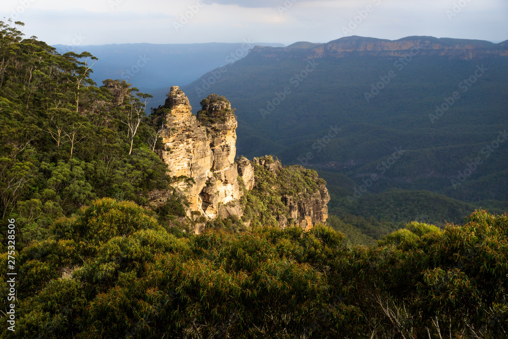 Two of the three sisters rock formation in the Blue mountains with orange last sunlight, Katoomba, New South Wales, Australia Two of the three sisters rock formation in the Blue mountains with orange last sunlight, Katoomba, New South Wales, Australia