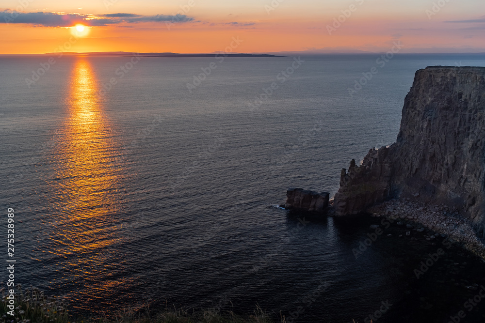 Stunning golden sunset from the Cliffs of Moher looking out towards the island of Inisheer, Ireland Stunning golden sunset from the Cliffs of Moher looking out towards the island of Inisheer, Ireland