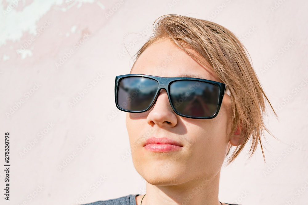 Young th guy in sunglasses on the street Young th guy in sunglasses on the street