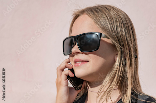 Teen girl with glasses with phone