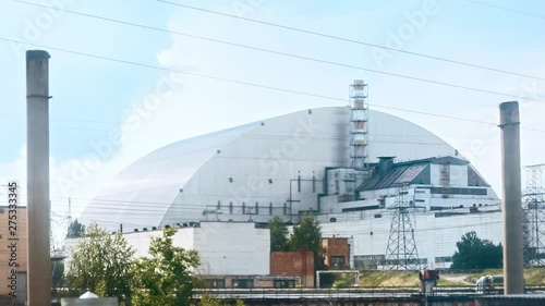 Incredible dark tour to mysterious Chernobyl exclusion zone. View of large nuclear power plant with a protective shelter on fourth block with reactor. photo