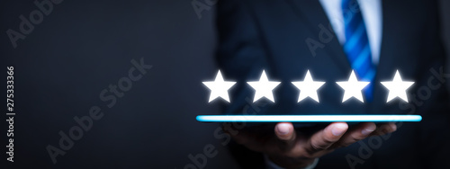 Increase rating company or ranking, evaluation and review concepts. Businessman rating five stars with copy space photo