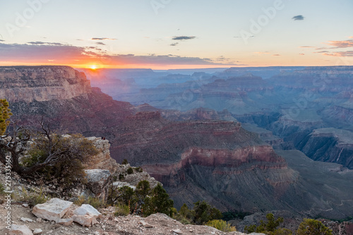 The setting sun sinking below the horizon of the Grand Canyon  near Yavapai point on the southern canyon rim.