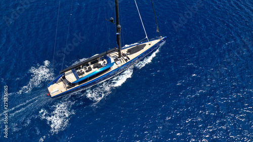 Aerial photo of beautiful wooden deck sail boat cruising the Aegean blue sea, Greece © aerial-drone