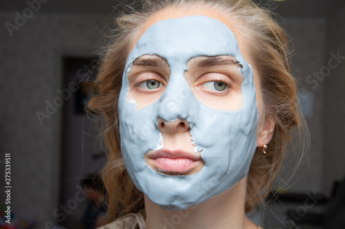 Spa Woman applying Facial clay Mask. Beauty Treatments.facial cleansing, cosmetology, beauty mask