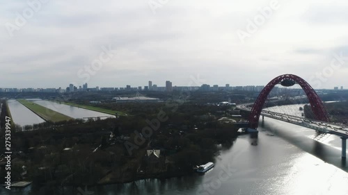 Aerial view of picturesque bridge over the Moscow-river and road traffic, the prospectus of Marshal Zhukov with moving cars against cloudy sky. Scene. Moscow skyline in summer photo