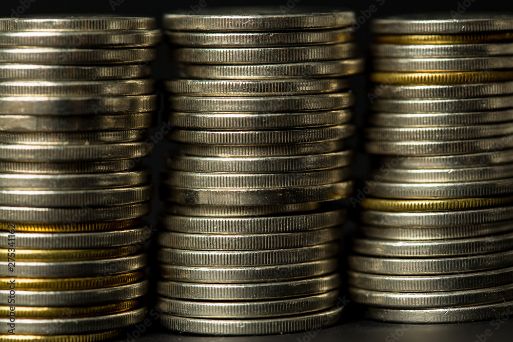 coins stacked on each other in different positions. in black background coins stacked on each other in different positions. in black background