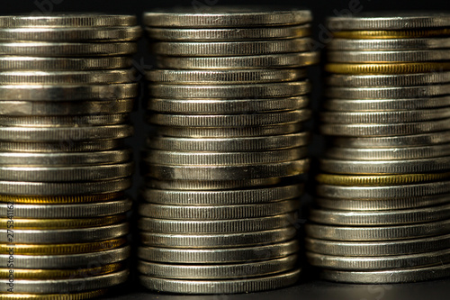 coins stacked on each other in different positions. in black background