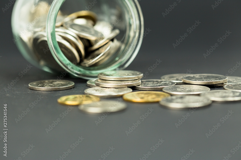 Stack of Coins in a glass jar on isolated background use for Business , finance , saving money or investment concept Stack of Coins in a glass jar on isolated background use for Business , finance , saving money or investment concept