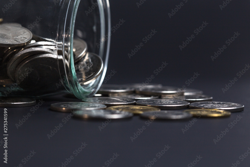 Stack of Coins in a glass jar on isolated background use for Business , finance , saving money or investment concept