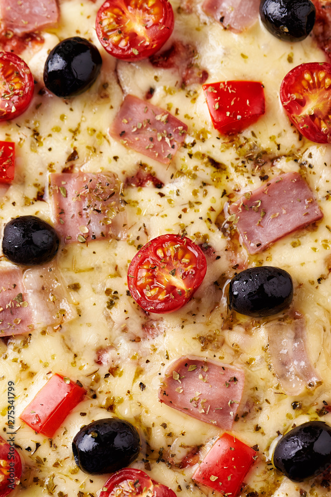 Pizza with ham, mozzarella cheese, cherry tomatoes, red pepper, black olives and oregano. Home made food. Concept for a tasty and hearty meal. Top view. Close up. Pizza with ham, mozzarella cheese, cherry tomatoes, red pepper, black olives and oregano. Home made food. Concept for a tasty and hearty meal. Top view. Close up.
