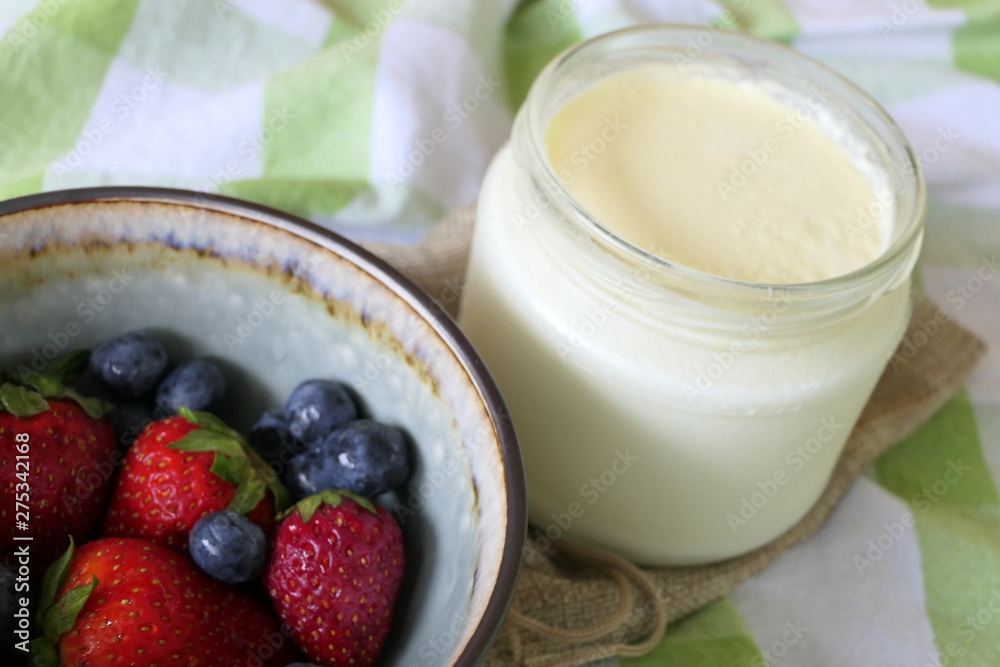 Homemade Yoghurt with Fresh Strawberries and Blueberries on a Wooden Background Homemade Yoghurt with Fresh Strawberries and Blueberries on a Wooden Background