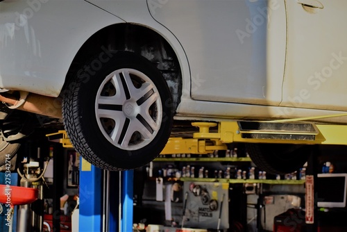 Car on a lift in the auto body shop