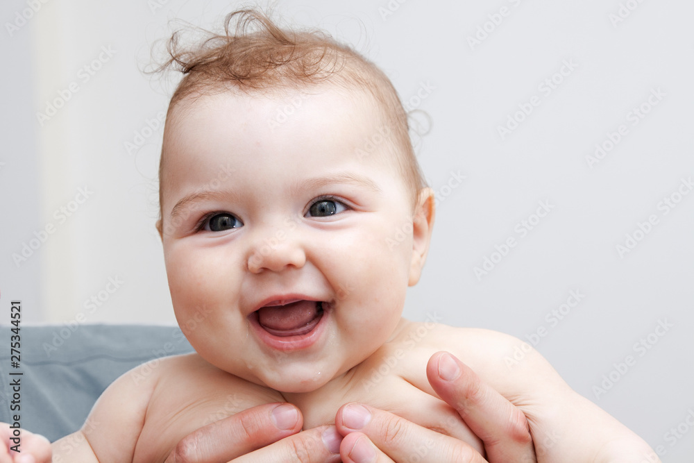 Healthy cheerful little baby smiling in his father's arms Healthy cheerful little baby smiling in his father's arms