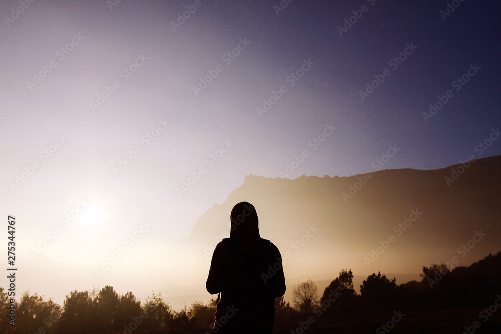 Silhouette of a man against the backdrop of misty mountains. Female silhouette on the background of misty mountains. Silhouette of a man against the backdrop of misty mountains. Female silhouette on the background of misty mountains.