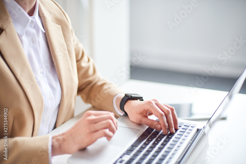 Mid age businesswoman working at the laptop in office