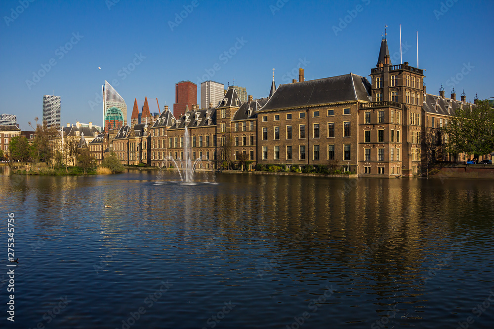 the Hague (den Haag), the Netherlands, Holland,, April 20, 2019. Binnenhof palace (Dutch Parliament), Mauritstoren (tower of Maurits) pond with fountain view side