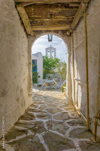 Fototapeta Naklejka Na Ścianę i Meble -  Street view of Chorio with paved alleys and traditional cycladic architecture in Kimolos island in Cyclades, Greece
