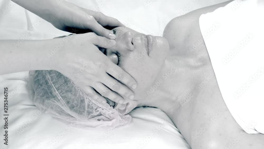 Beautiful adult woman doing facial massage at the beauty salon. Beautiful adult woman doing facial massage at the beauty salon.