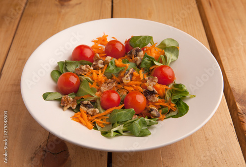Healthy salad with cherry tomatoes   canons and grated carrot .