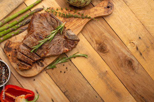 Steak with vegetables on a wooden background, restaurant and hotel business, menu, homemade recipes, culinary background, horizontal photo, banner photo