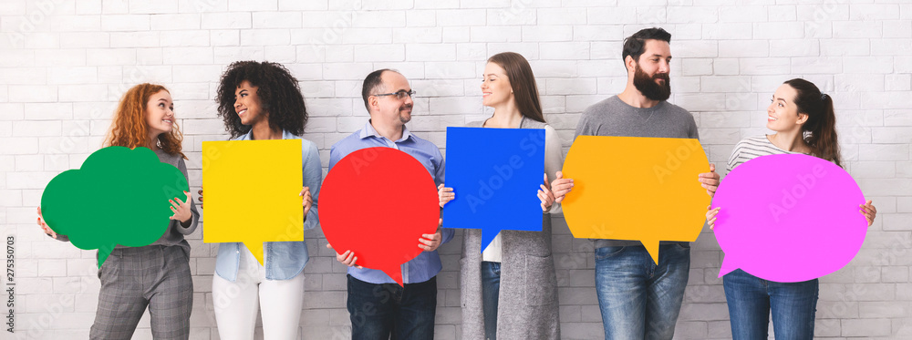 Cheerful diverse people holding empty colorful speech bubbles - obrazy, fototapety, plakaty 