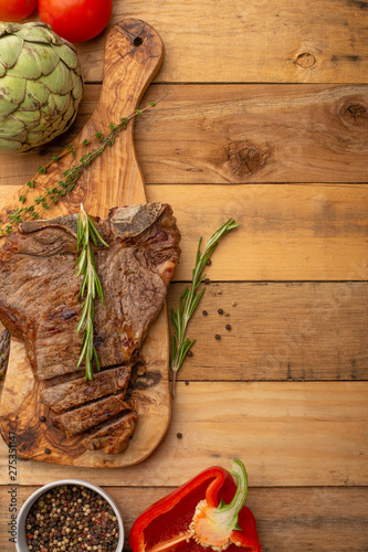 Steak with vegetables on a wooden background, restaurant and hotel business, menu, homemade recipes, culinary background, vertical photo, banner photo