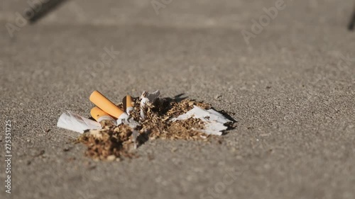 a woman tramples cigarettes on asphalt, stop smoking, quit smoking