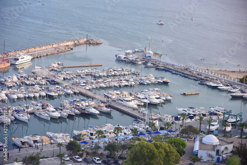 The scenic coastline of Sidi Bou Said with the large haven, full of yachts. Yachts and boats in the port of Sidi Bou Said, Tunisia