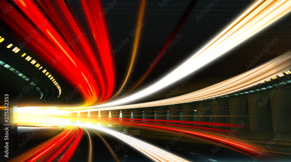 Modern cars driving through illuminated highway tunnel