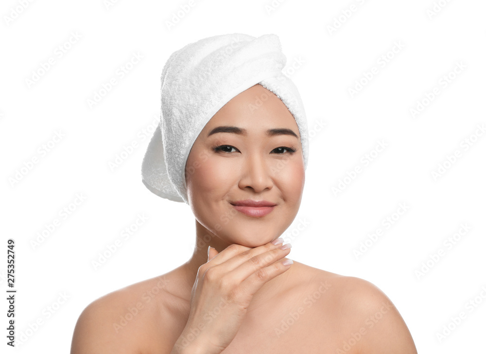Portrait of beautiful Asian woman with towel on head against white background. Spa treatment Portrait of beautiful Asian woman with towel on head against white background. Spa treatment