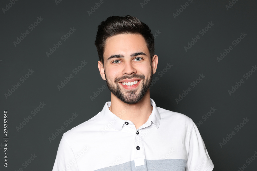 Portrait of handsome smiling man on grey background Portrait of handsome smiling man on grey background