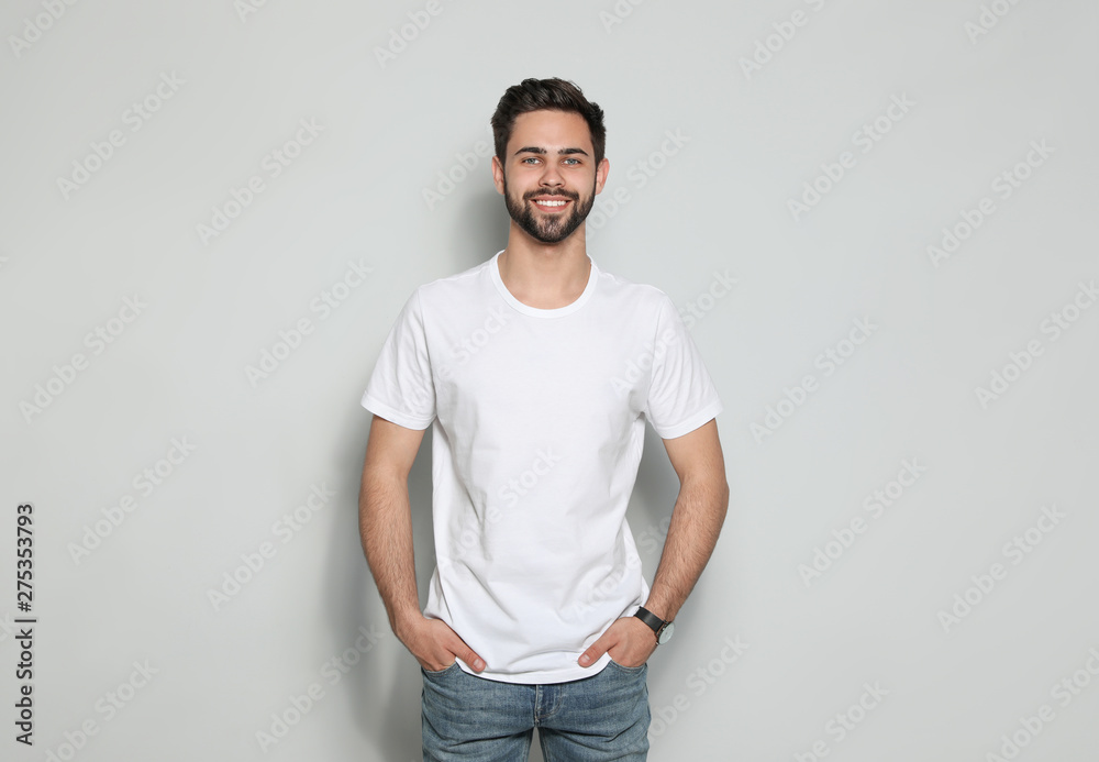 Young man in t-shirt on light background. Mock up for design - obrazy, fototapety, plakaty 