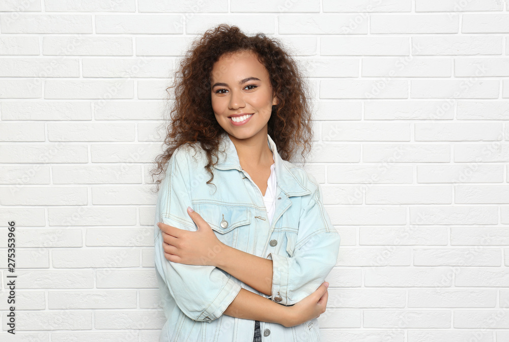 Young African-American woman with beautiful face near white brick wall Young African-American woman with beautiful face near white brick wall