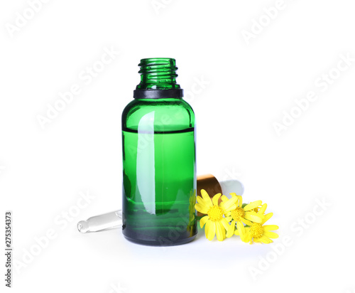 Bottle of herbal essential oil, pipette and flowers isolated on white