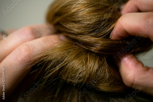 closeup of woman fixing messy hair