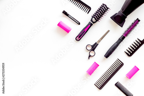Combs and pink hairdresser tools in beauty salon work desk on white background top view mockup