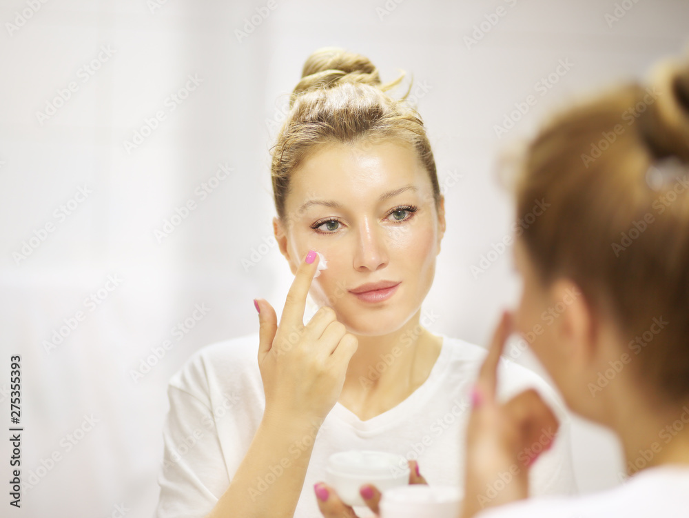 Magic anti-aging cream.Applying the cream