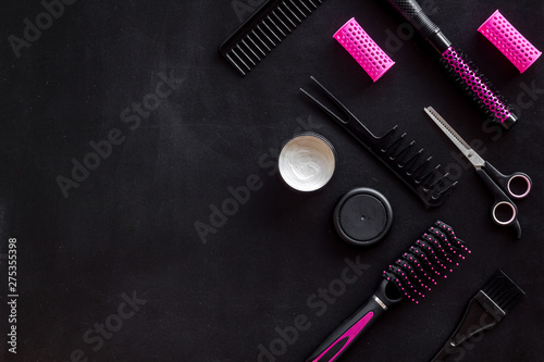 Fototapeta Naklejka Na Ścianę i Meble -  Hairdresser equipment for cutting hair and styling with combs, sciccors, brushes on black background top view copyspace