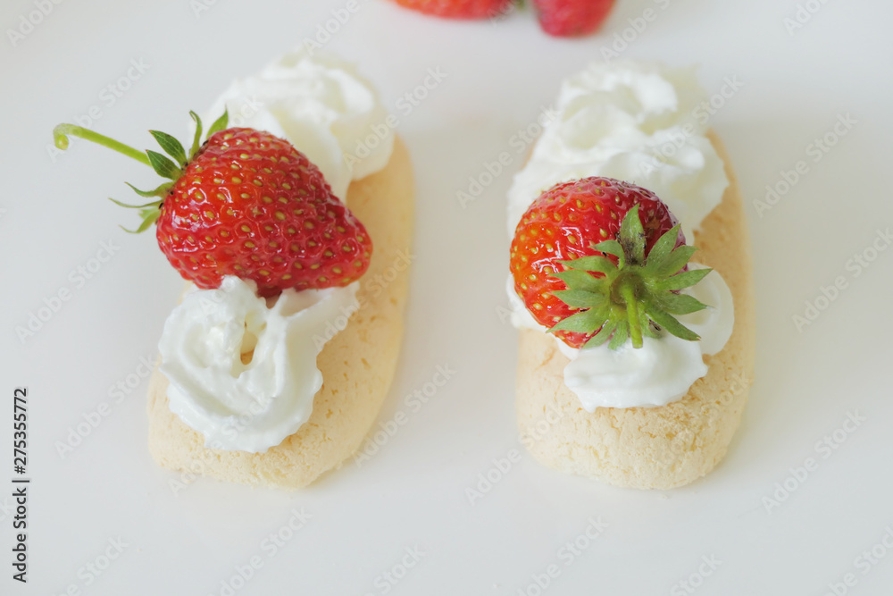 Biscuits with Cream and Strawberries isolated on a White Background Biscuits with Cream and Strawberries isolated on a White Background